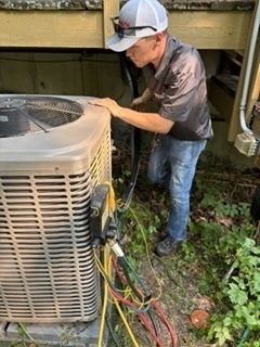 Garrett Hernandez servicing an outdoor AC condenser unit